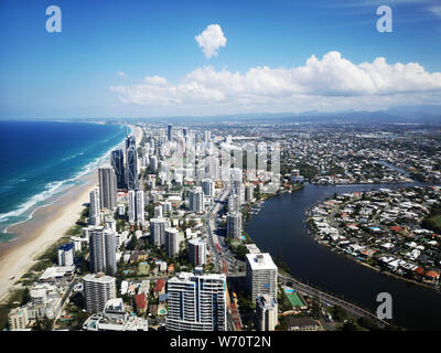 Surfers Paradise along the Gold Coast in Queensland, Australia - aerial view of the coastline with high rise hotels overlooking the beach.