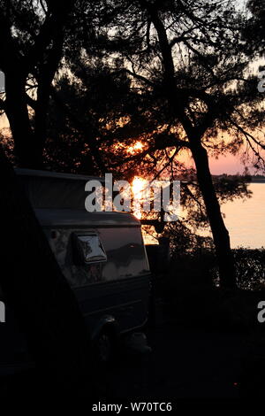 An old little caravan in the woods Stock Photo