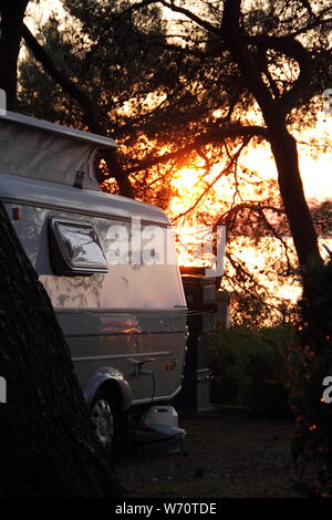 An old little caravan in the woods Stock Photo