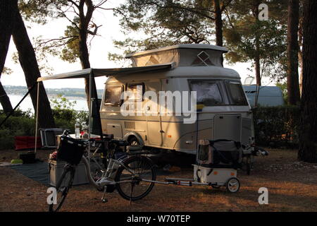 An old little caravan in the woods Stock Photo