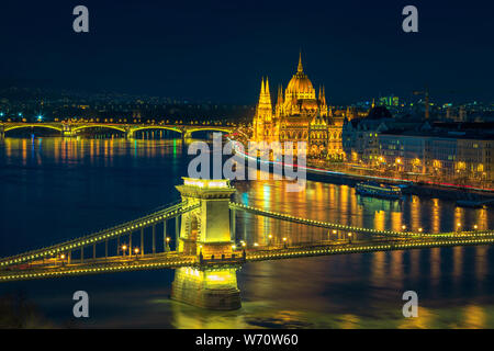 Popular European touristic and travel destination. Picturesque cityscape panorama with amazing illuminated Chain bridge and Hungarian Parliament build