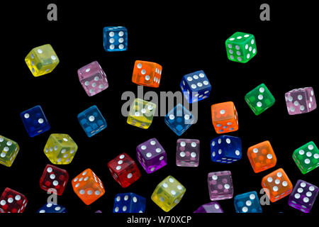 many falling translucent  multicolored  dices with white dots on black background Stock Photo