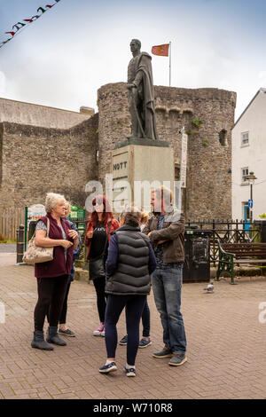 UK, Wales, Carmarthenshire, Carmarthen, Nott Square, people talking by castle, under statue of Anglo-Afghan war hero Major-General Sir William Knott Stock Photo