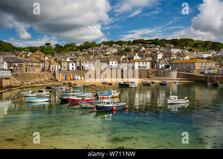 UK, England, Cornwall, Mousehole, boats moored in harbour at low tide below South Cliff