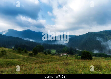 Foggy morning over Chairski lakes chalet in Rhodope mountain, Bulgaria Stock Photo