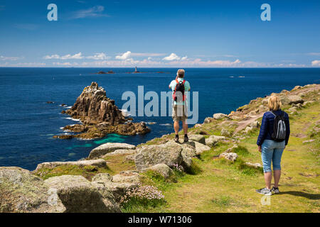 UK, England, Cornwall, Sennen, Land’s End, walkers photographing Armed Knight island from Coast Path Stock Photo