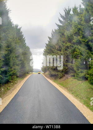 Brezovica, Serbia - April 30, 2019: Asphalt machines set up on the route and workers start ascending the road to Brezovica, Serbia Stock Photo