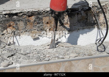 demolish an old staircase with a demolition hammer Stock Photo