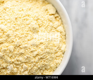 Nigerian dried pap (cornmeal or corn starch) in a white bowl, off centre to the left Stock Photo