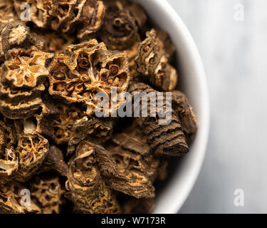 Sliced and dried okra (lady's fingers) in a white bowl, off centre to the left Stock Photo