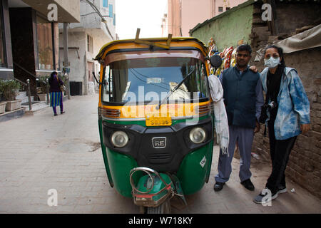 Travelers thai women journey visit and travel posing portrait take photo with Indian man people driver tuk tuk taxi at Delhi city on March 18, 2019 in Stock Photo