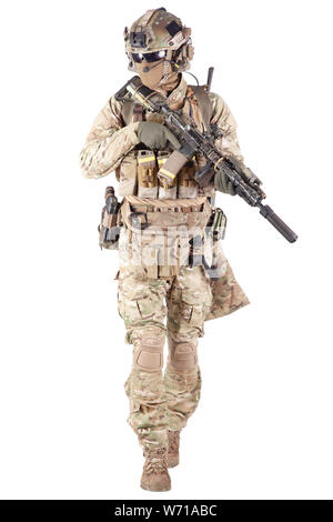 Strikeball enthusiast in checkered shirt wearing military ammunition, face mask, helmet and radio headset, tactical glasses, camo pants, armed service rifle and handgun studio shoot isolated on white Stock Photo