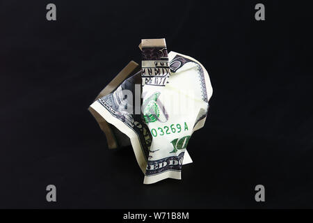 Crumpled one hundred American dollar on black paper background, close-up of bad money. The collapse of the dollar. Devaluation. Falling currency. Stock Photo