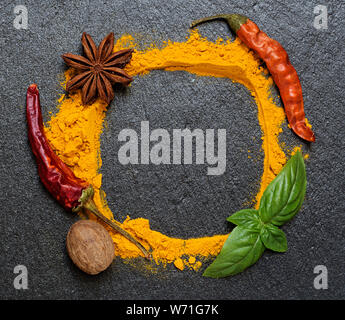 Spices frame on black granite board Stock Photo