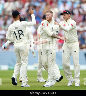 England's Ben Stokes (centre) celebrates with Moeen Ali (left) and Joe Root after taking the wicket of Australia's Travis Head during day four of the Ashes Test match at Edgbaston, Birmingham. Stock Photo