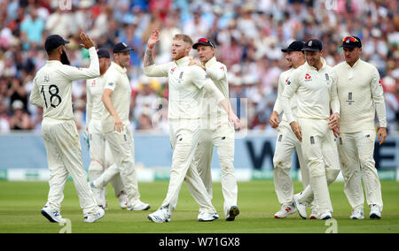 England's Ben Stokes (centre) celebrates with Moeen Ali (left) and Joe Root after taking the wicket of Australia's Travis Head during day four of the Ashes Test match at Edgbaston, Birmingham. Stock Photo