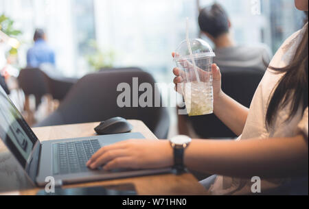Young woman on work with drinking tea for refreshments Stock Photo