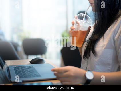Young woman on work with drinking tea for refreshment Stock Photo