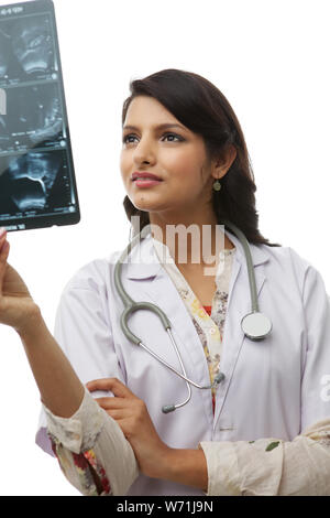 Male doctor discussing with his colleague an x-ray report Stock Photo