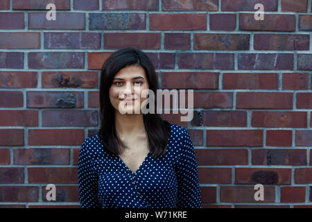 Portrait of young woman smiling gently at camera Stock Photo