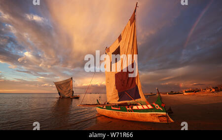 Traditional fishing pirogues at sunset with dramatic sky after a thunderstorm in Anakao, Madagascar Stock Photo