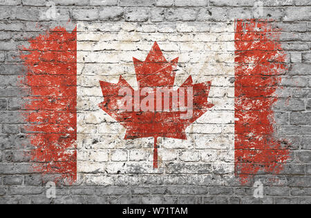 Grunge distressed flag of Canada painted on old weathered grey brick wall Stock Photo