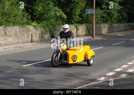 AA Moto Guzzi motorcycle & side-car en-route to Lytham Hall classic vintage motorcycles, collectable transport festival, moving trikes, movement, UK roads vintage vehicles show. The Festival of Transport diverse range of classic heritage prestige bikes. Stock Photo