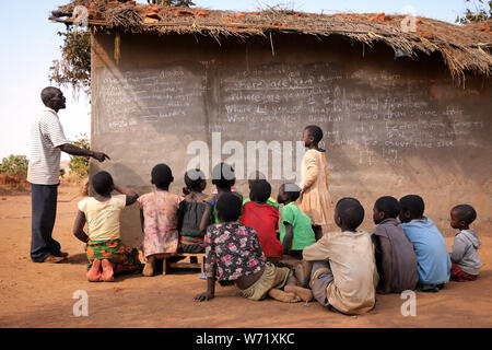 Students and teacher in a classroom of a primary school in a remote village near Ntchisi. Malawi is one of the poorest countries in the world. Stock Photo