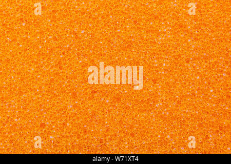 Orange foam rubber texture background. Stock Photo