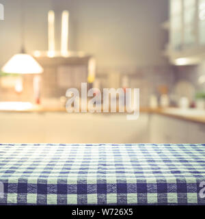 Checkered tablecloth texture top view with blur kitchen room background.For montage product display or design key visual layout. Stock Photo