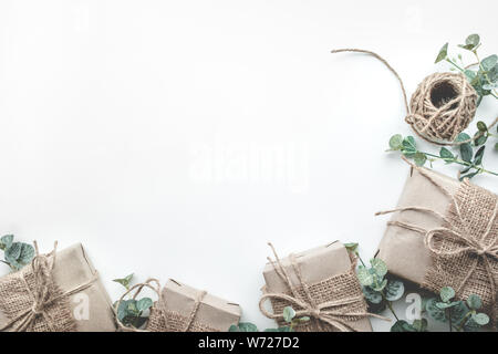 Gift boxes collection wrapped in kraft paper minimal style with leaves on white background.For special gift concepts ideas.Flat lay template design Stock Photo