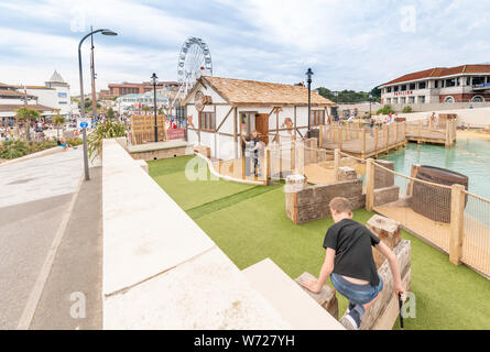 Bournemouth, UK. 4th August 2019. Tourist try out the new Smugglers Cove Adventure Golf on the seafront in Bournemouth, newly opened this week. Credit: Thomas Faull/Alamy Live News Stock Photo