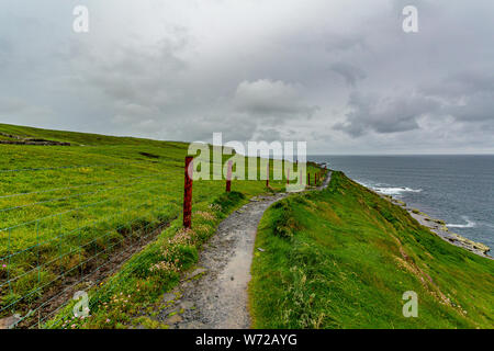 Landscape of the coast and a rural footpath in of the coastal route walk from Doolin to the Cliffs of Moher, geosites and geopark, Wild Atlantic Way