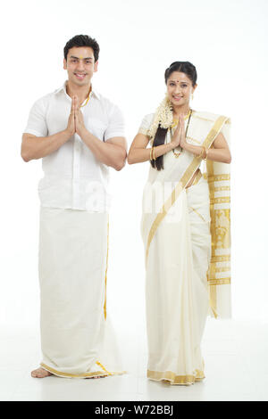 south indian couple welcoming with hands joined w72bbj