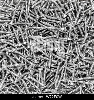 Metal screws background, black and white industrial iron texture Stock Photo