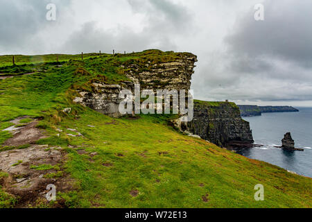 Countryside landscape in the Cliffs of Moher with the Branaunmore sea stack, geosites and geopark, Wild Atlantic Way, wonderful cloudy spring day