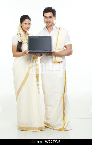South Indian couple showing a laptop Stock Photo