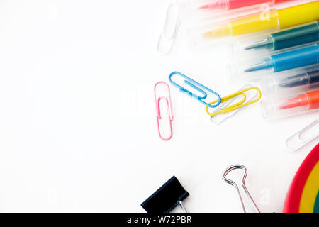 Colorful stationary school supplies on white background, space or text flat layer. Stock Photo