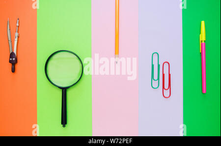 back to school. Colorful stationary school supplies on different colorful background, space or text flat lay. Stock Photo