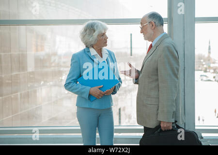 Senior business colleagues man and woman having conversation at work Stock Photo