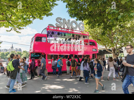 London / UK, July 15th 2019 - Snog Frozen Yoghurt vendor operates from a pink bus on Queens walk beside the river thames Stock Photo