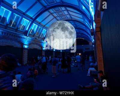 The Museum of the Moon touring artwork by UK artist Luke Jerram at the Natural History Museum London being viewed by crowds of people Stock Photo