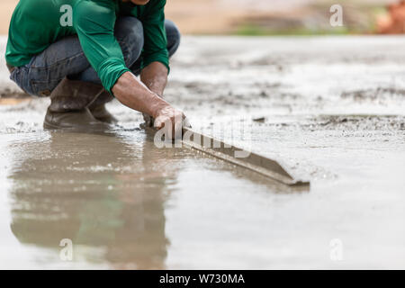 Work industrial concept : Pouring and sweep the wet cement on the floor in process of house building Stock Photo