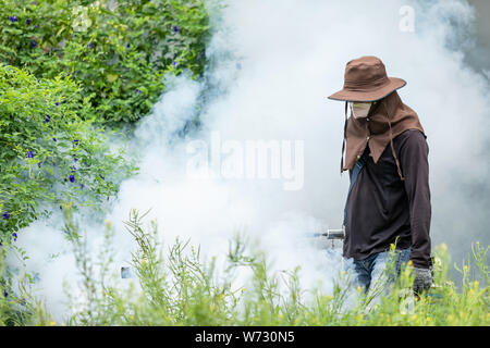 Mosquito repellent concept : A man fogging chemical to eliminate mosquito at the street Stock Photo