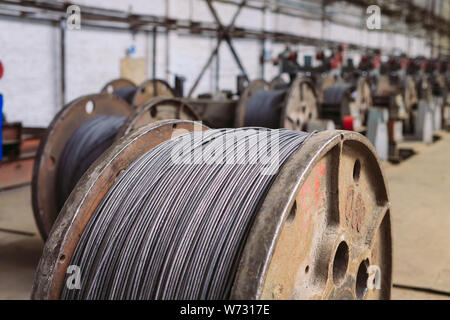 Wire rod, fittings in warehouses. industrial storehouse at the metallurgical plant. Stock Photo