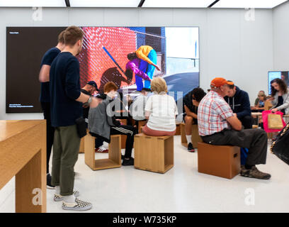 Customers browsing in an Apple Store Stock Photo