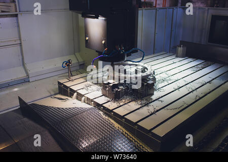 Worker male hands working with CNC machine at factory with lathes. Stock Photo