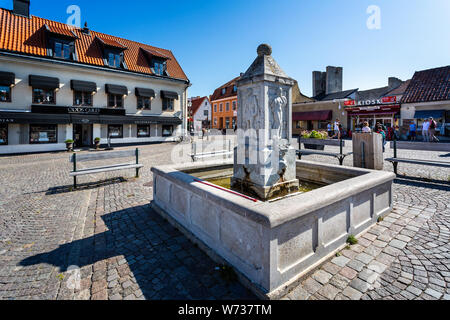 Small town fountain in the centre of the Hanseatic town of Visby, Gotland, Sweden on 20 July 2019 Stock Photo