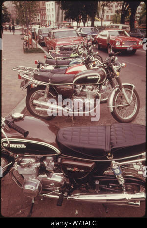 THOSE PEOPLE WHO OWNED MOTORCYCLES TURNED TO THEM FOR COMMUTING IN GREATER NUMBERS THAN USUAL DURING A BUS STRIKE IN WASHINGTON, DISTRICT OF COLUMBIA, IN MAY, 1974. SOME 250,000 PERSONS WERE FORCED TO FIND ALTERNATE METHODS OF TRANSPORTATION, USUALLY THE AUTO. MONUMENTAL TRAFFIC JAMS RESULTED AS DRIVERS LEARNED THERE WERE MORE AUTOS THAN PLACES TO PARK LEGALLY. DRIVERS USED TRAFFIC ISLANDS, BUS LANES, SIDEWALKS AND LAWNS. POLICE ISSUED VERY FEW TICKETS BECAUSE OF THE STRIKE Stock Photo