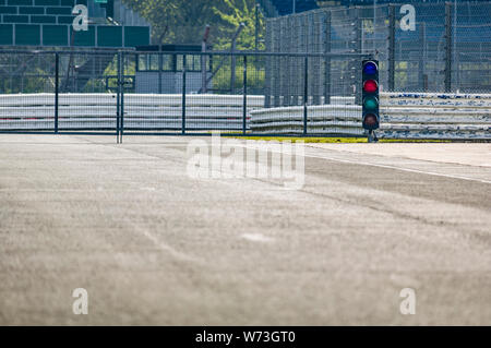 Traffic light at the exit of the deserted original pit lane at Silverstone race track. Stock Photo